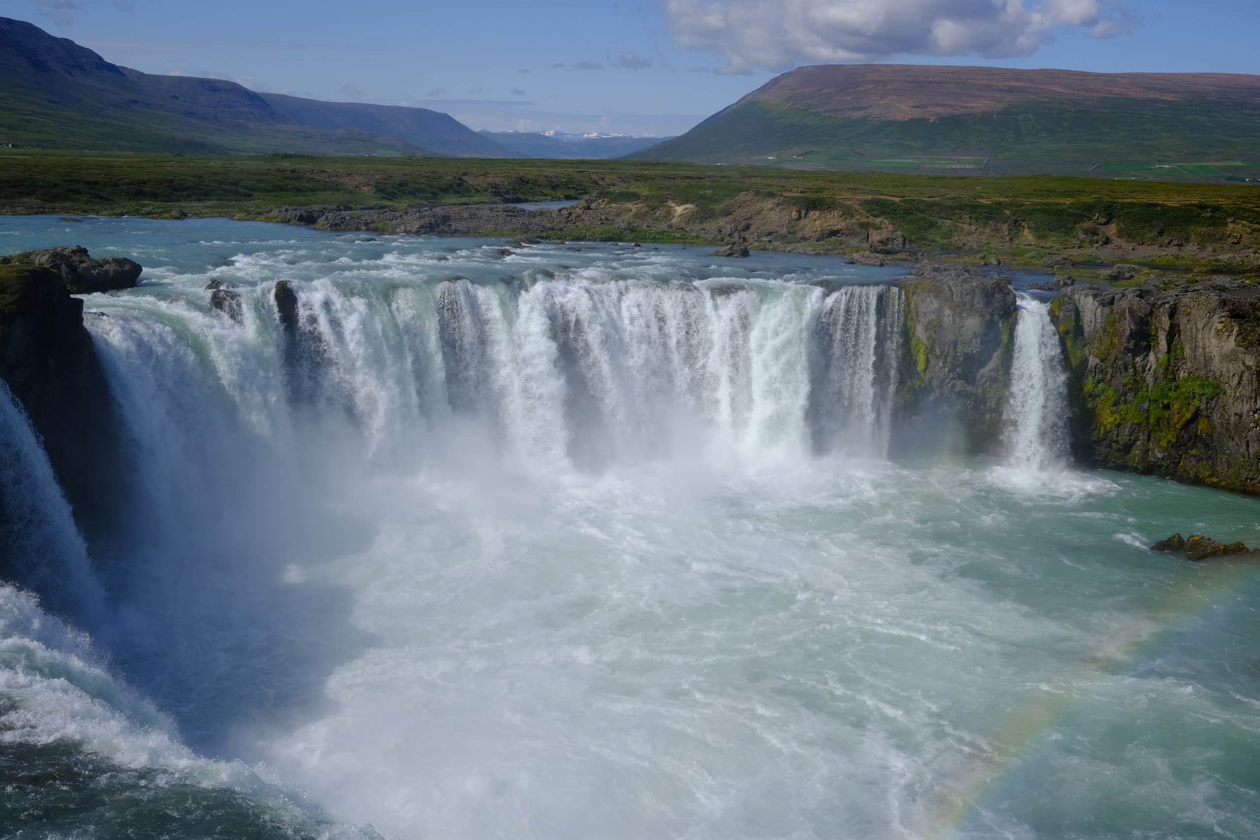 Powerful Icelandic waterfall cascading into a misty turquoise basin, capturing nature’s energy and clarity for the Neuromystics healing and mindfulness shop.